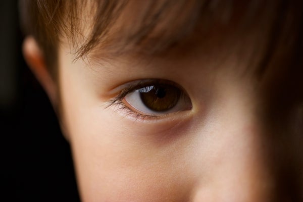 macro shot of young half-asian half-white boy's eye with dramatic lighting
